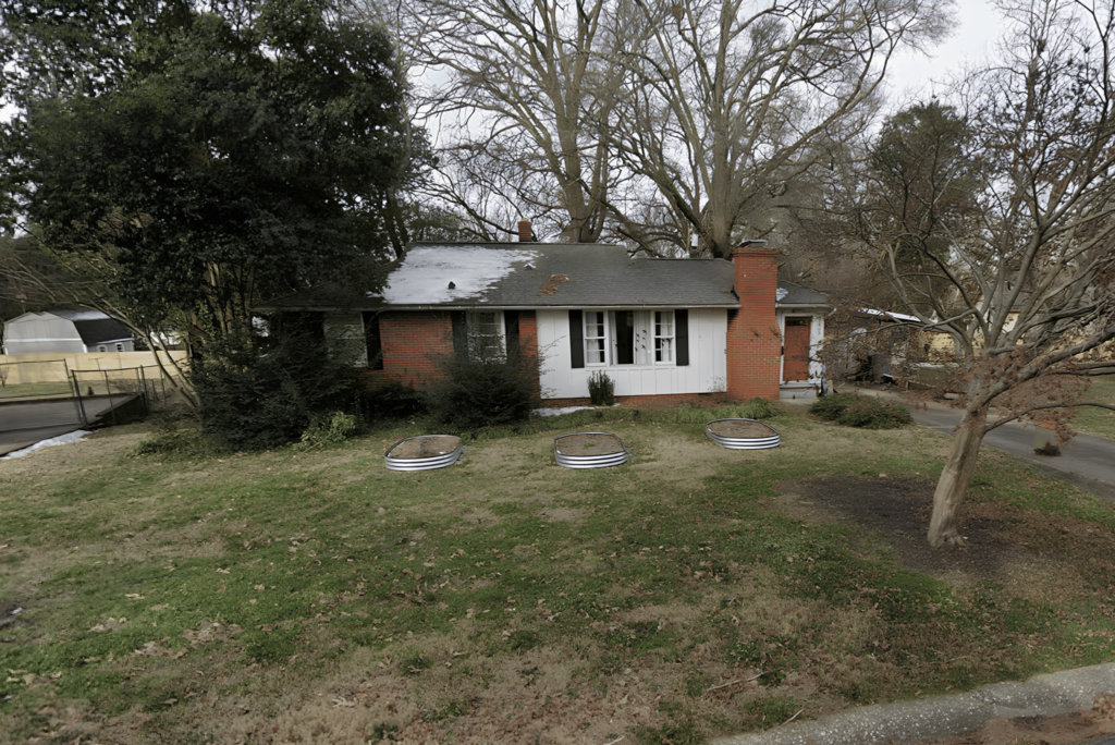 Existing brick ranch home in Charlotte, NC, site of a Hammerhead Capital 3-unit townhome scrape and build project